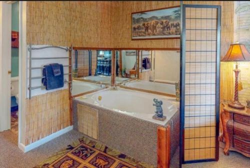 a bathroom with a bath tub in a room at Jacuzzi Suite 205 at Tradewinds in Eureka Springs