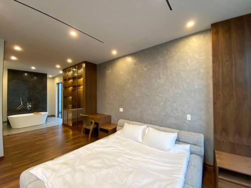 a bedroom with a large bed and a bath tub at Song Cat villa - 49DP8 in Danang