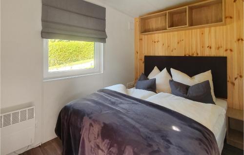 a bedroom with a large bed with a window at Visam Weg 32 in Untergriesbach
