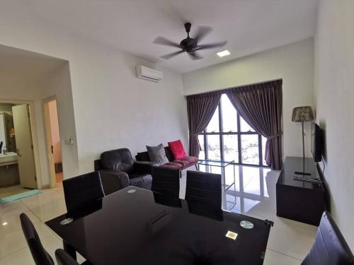 a living room with a table and a couch at Icon Residenz Icon City, Petaling Jaya by De Harlequins Guesthouse in Petaling Jaya