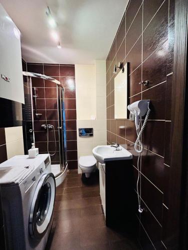 a bathroom with a washing machine and a washer at Sopot Marina Beach Elegance in Sopot