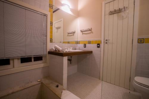 a bathroom with a sink and a shower and a toilet at Villa Don in Petrópolis