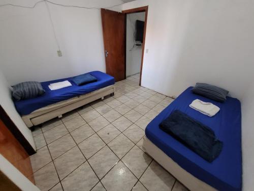 a room with two beds in a room with a door at ADE águas claras 01 in Brasilia