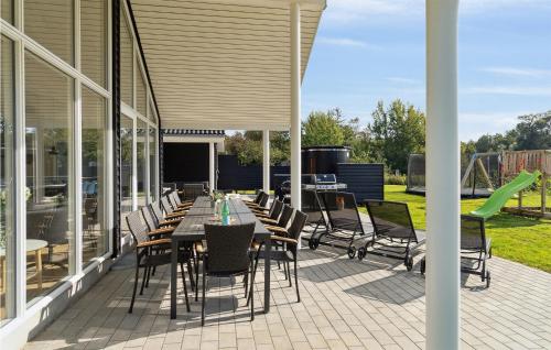 a patio with a table and chairs on it at Stunning Home In Jægerspris With Sauna in Jægerspris
