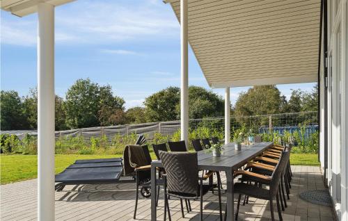 a patio with a table and chairs on a deck at Stunning Home In Jægerspris With Sauna in Jægerspris