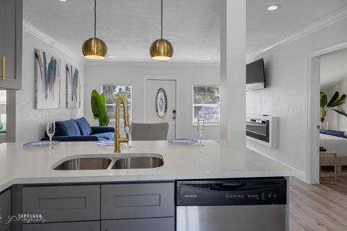 a kitchen with a sink and a counter top at West Palm Beach Tropical Oasis in West Palm Beach