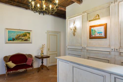 a room with a chandelier and a table and a chair at Relais San Giacomo in Maiori
