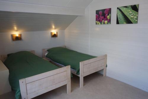 Ένα ή περισσότερα κρεβάτια σε δωμάτιο στο Vakantiewoning NOORDERSTEK