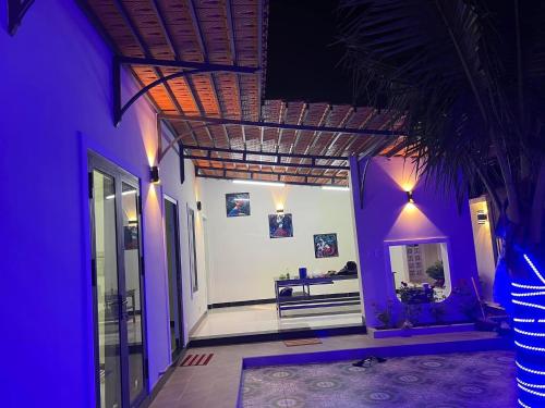 a hallway of a house with purple lights at Villa Ngọc Châu Phan Thiết Chi nhánh 2 - 4 Phòng Ngủ, Có Bếp, Phòng Ăn, Phòng Khách, Miễn Phí Sân BBQ và Bãi Xe Ô Tô Rộng Rãi in Phan Thiet