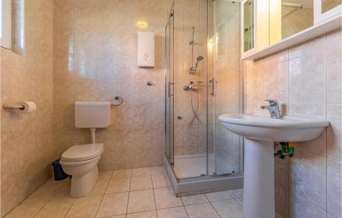 a bathroom with a toilet and a sink and a shower at Amazing Apartment In Medulin With 3 Bedrooms And Wifi in Medulin