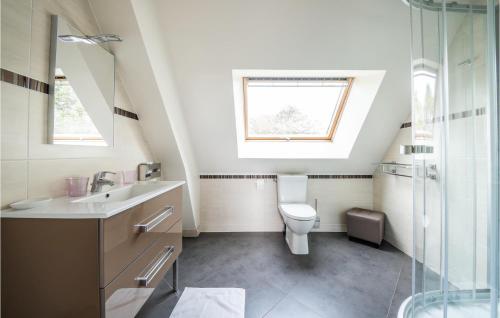 a bathroom with a toilet and a sink and a window at Awesome Home In Paluel With Wifi And 3 Bedrooms in Paluel