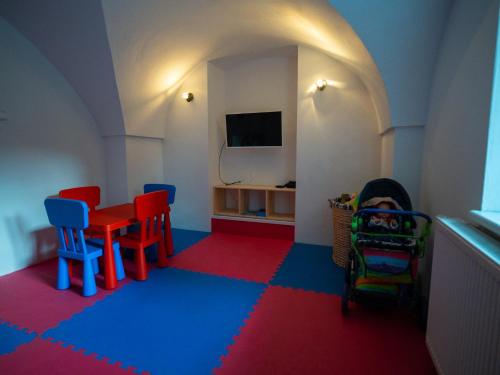 a lego room with a table and chairs and a tv at Rodinná chalupa Ostašovka Liberec in Liberec
