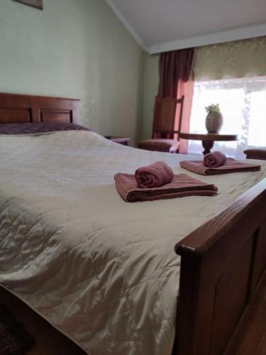 a large bed with two towels on top of it at Diamond De Luxe in Kolomyya