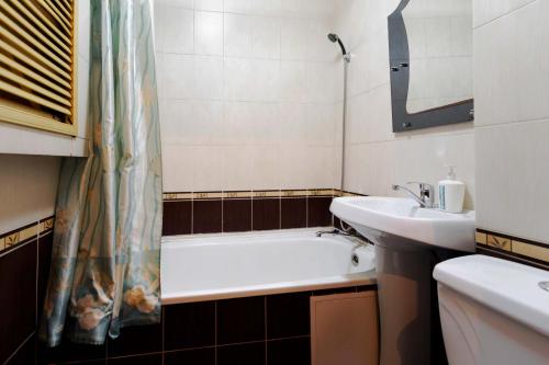 a bathroom with a sink and a bath tub at Толедо in Petropavlovsk