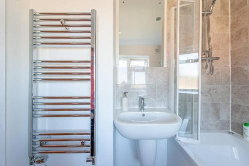 a bathroom with a sink and a toilet and a shower at Stylish apartment, Taunton in Taunton