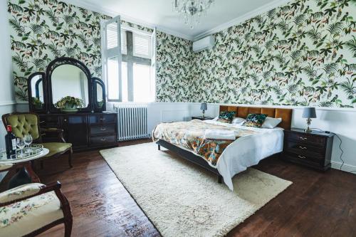 1 dormitorio con cama y papel pintado con motivos florales en Chateau La Croix De Millorit, 