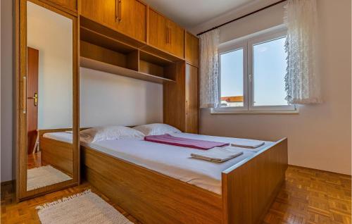 a bedroom with a bed with a large mirror at Amazing Apartment In Medulin With 3 Bedrooms And Wifi in Medulin