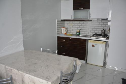 a kitchen with a table and a counter top at Hera Rezidans in Kırac