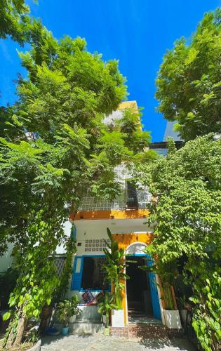 a building with trees in front of it at Loka Home & Yoga in Da Nang