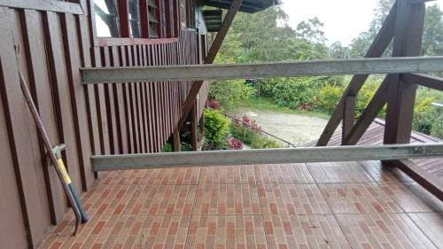 a railing on a porch with a brick walkway at Mountainresthouse 
