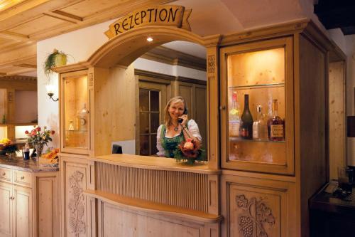 a woman talking on a cell phone in a bar at Hotel - Landgasthof Rebstock in Nimburg