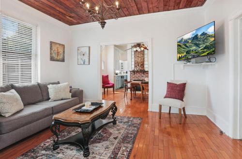 a living room with a couch and a table at Redstick Cottage in Baton Rouge