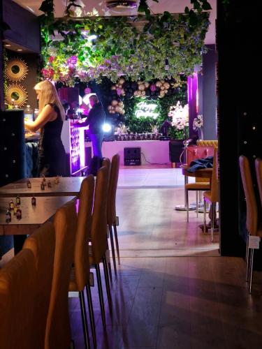 a man and woman standing at a bar on a stage at Regency Hotel in Leicester