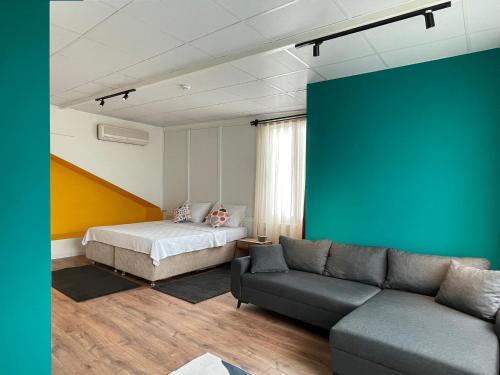 a living room with a bed and a couch at Cabbana Hotel Lara in Antalya