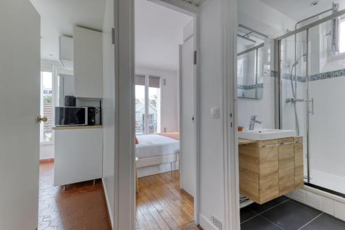 a bathroom with a sink and a mirror at Countryside in Paris 14 - Lovely and Calm 1bd Flat in Paris