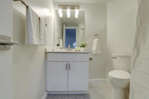 a white bathroom with a sink and a toilet at Bright & Modern Apartment in Pentagon City in Arlington