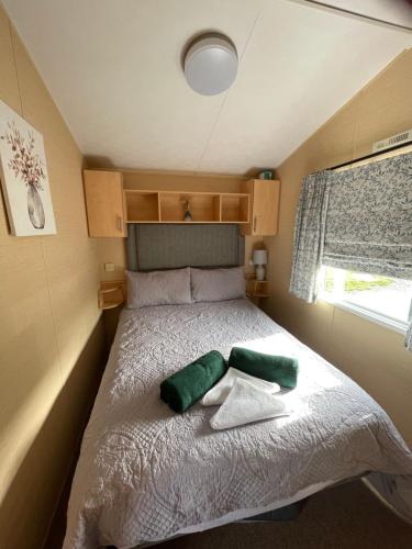 a small bedroom with a bed with towels on it at Jone’s Cove in Swanage