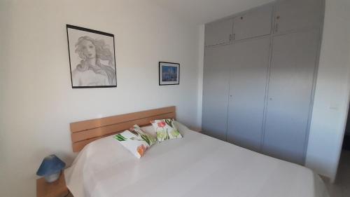 - une chambre avec un lit blanc et un placard blanc dans l'établissement 50 m2 - Le PORT, HYERES, à Hyères