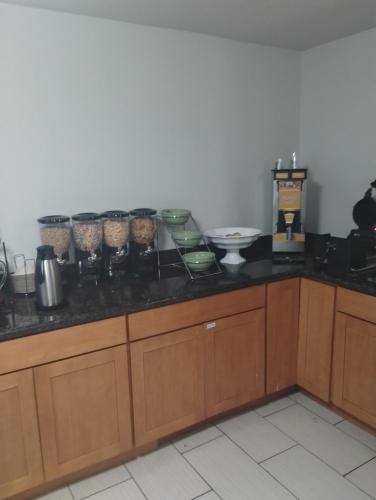 a kitchen with a counter with alot of food on it at Quality Inn & Suites Wilsonville in Wilsonville