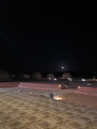 a skate park at night with lights in the background at Yellow Star Camp Wadi Rum in Wadi Rum