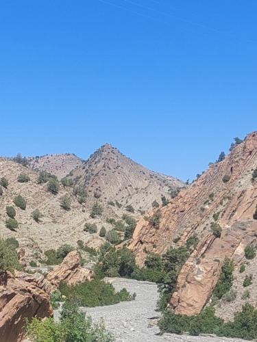 a river in the middle of a rocky mountain at KASBAH Atlas-Aberdouz in Aït Hattab