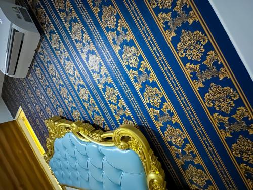 a blue and gold room with a blue and gold wall at Disneyland Theme DFB homestay 03 Gala City Armadale Residence in Kuching