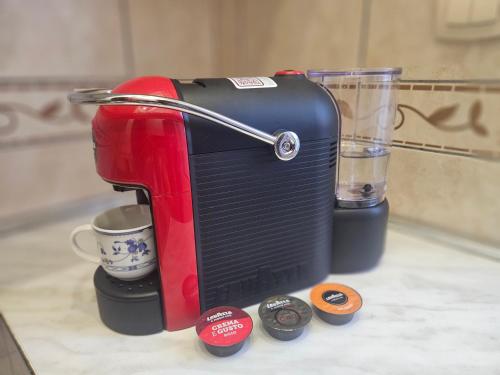 a coffee maker sitting on a counter with a cup of coffee at Aпартаменты Влаович in Igalo