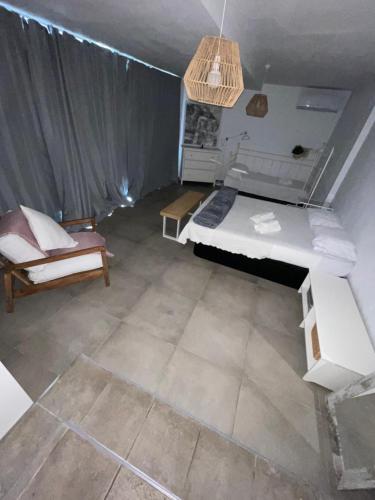 a room with a bed and a couch and a table at MEDITERRANEAN HOUSE - Habitaciones Privadas en Casa Compartida in Mairena del Aljarafe