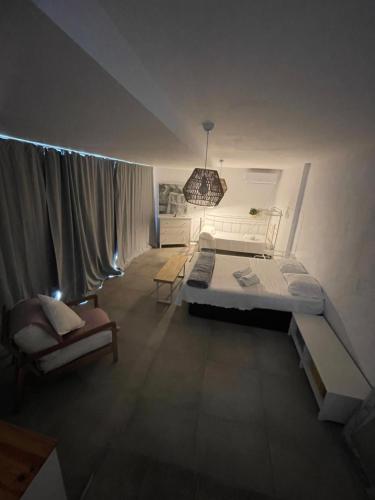 a bedroom with a bed and a chair in it at MEDITERRANEAN HOUSE - Habitaciones Privadas en Casa Compartida in Mairena del Aljarafe