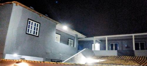 a house at night with lights on the side of it at Apartamentos SOLAR PALMER in Cabo Frio