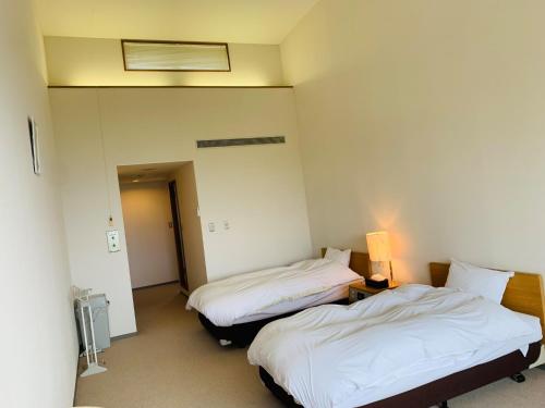 a hotel room with two beds and a light at Starry Sky and Sea of Clouds Hotel Terrace Resort - Vacation STAY 75205v in Takeda