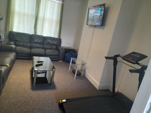 a living room with a couch and a flat screen tv at ACCANE in Monkwearmouth