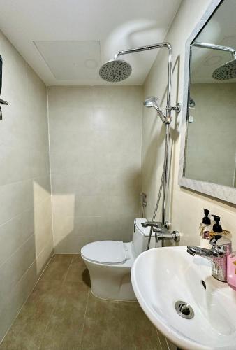 a bathroom with a toilet and a sink and a mirror at Loka Home & Yoga in Da Nang