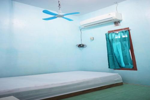 a hospital room with a ceiling fan and a bed at OYO Life 93017 Kost H Soeroso in Situbondo