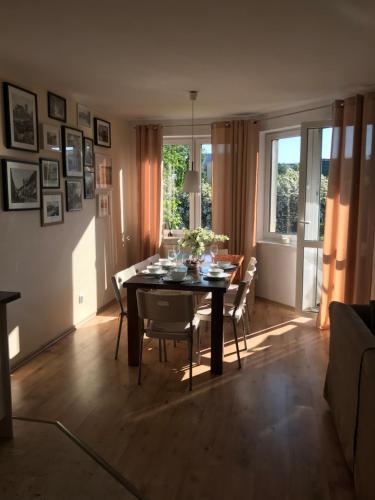 a dining room with a table and chairs and a window at Nella in Darłowo