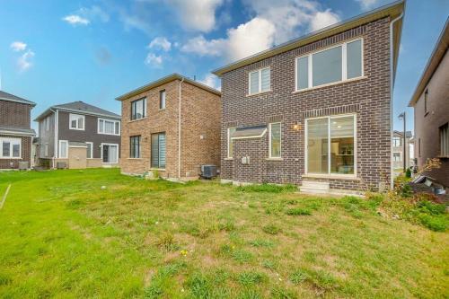 a brick house with a lawn in the yard at 922 Logan Drive in Milton