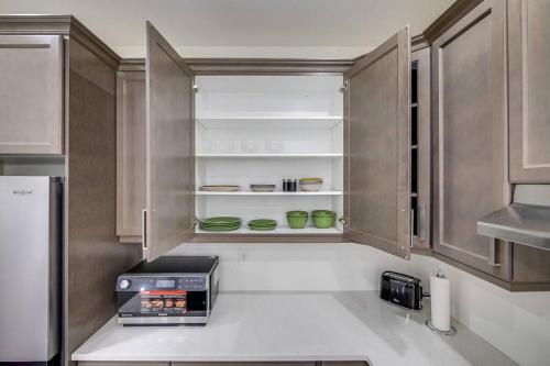 a kitchen with wooden cabinets and a toaster oven at 922 Logan Drive in Milton