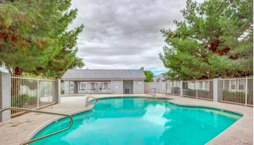 Una gran piscina azul frente a una casa en Cozy 3 Bedrooms Town home in Chandler with community pool, en Chandler