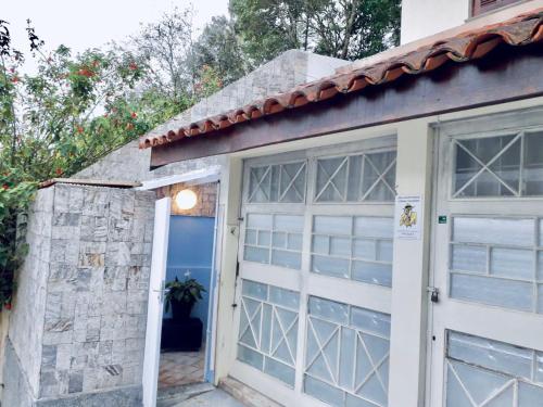 a garage with a white door and a stone wall at Próximo shopping Beira Mar in Florianópolis