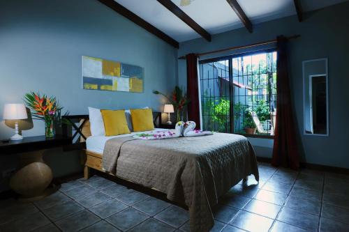 a bedroom with a bed and a large window at Private Fully Furnished Home at Wide Mouth Frog Hostel Quepos in Quepos